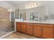 Primary bathroom featuring a dual sink vanity and glass enclosed shower at 14188 Walcott Ave, Orlando, FL 32827