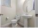 Cozy half bath with pedestal sink, toilet and window at 14188 Walcott Ave, Orlando, FL 32827