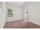 Bright bedroom featuring a window with natural light and carpeted flooring at 14188 Walcott Ave, Orlando, FL 32827