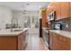 Bright kitchen featuring tile floors, stainless steel appliances, granite counters and ample wood cabinets at 14188 Walcott Ave, Orlando, FL 32827