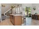 Modern kitchen island with bar stool seating, seamless flow to the bright living room at 14188 Walcott Ave, Orlando, FL 32827