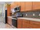 Sleek kitchen with stainless steel appliances, stylish backsplash, and modern countertops at 14188 Walcott Ave, Orlando, FL 32827