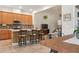 Open concept kitchen featuring an island, modern appliances and stylish bar stools at 14188 Walcott Ave, Orlando, FL 32827