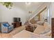 Bright living room featuring neutral decor, staircase, high ceilings and large windows at 14188 Walcott Ave, Orlando, FL 32827