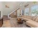 Open-concept living room with neutral tones, lots of natural light, and a modern staircase at 14188 Walcott Ave, Orlando, FL 32827