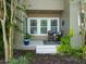 Covered patio with a table and chairs surrounded by lush greenery at 14188 Walcott Ave, Orlando, FL 32827
