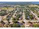 Overview of suburban neighborhood featuring tree-lined streets and well-maintained houses, with property outlined in red at 149 Southern Breeze Dr, Minneola, FL 34715