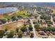 Aerial view of a residential area near a lake and open fields, showcasing a mix of housing and green space at 149 Southern Breeze Dr, Minneola, FL 34715