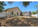 Backyard with a view of the screened-in pool, house exterior, and green landscaping at 149 Southern Breeze Dr, Minneola, FL 34715