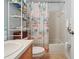 Bright bathroom with vanity, shower-tub combo, and beach-themed decor, offering a relaxing atmosphere at 149 Southern Breeze Dr, Minneola, FL 34715