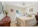 Cozy bedroom featuring a comfortable bed, dresser, and window overlooking the outdoor scenery for a relaxing retreat at 149 Southern Breeze Dr, Minneola, FL 34715
