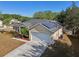 Well-maintained single-story home with a two-car garage, solar panels, and landscaped front yard at 149 Southern Breeze Dr, Minneola, FL 34715