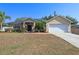 Attractive home with a well-kept lawn, mulch beds, and flowering plants for great curb appeal at 149 Southern Breeze Dr, Minneola, FL 34715