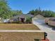 Charming single-story home featuring a manicured lawn, well-maintained landscaping, and a two-car garage at 149 Southern Breeze Dr, Minneola, FL 34715