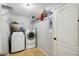 Functional laundry room featuring a washer, dryer, storage shelves, and ample space for organizing household tasks at 149 Southern Breeze Dr, Minneola, FL 34715