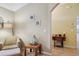 Comfortable living room with neutral walls, accent furniture, and view to another room through archway at 149 Southern Breeze Dr, Minneola, FL 34715
