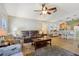 Comfortable living room with ceiling fan, tile flooring, and access to the dining area at 149 Southern Breeze Dr, Minneola, FL 34715