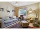 Cozy living room featuring a comfortable seating arrangement, accent tables, and a large window at 149 Southern Breeze Dr, Minneola, FL 34715