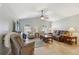 Cozy living room with vaulted ceilings, a ceiling fan and tile flooring at 149 Southern Breeze Dr, Minneola, FL 34715