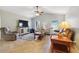 Living room featuring tile flooring, a ceiling fan, and comfortable seating at 149 Southern Breeze Dr, Minneola, FL 34715