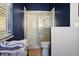 Bright bathroom featuring a glass-enclosed shower, toilet, and stacked towels in a wire basket at 149 Southern Breeze Dr, Minneola, FL 34715