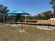 Community playground featuring swings and a covered play structure at 149 Southern Breeze Dr, Minneola, FL 34715