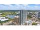 Stunning aerial view of the condo building overlooking a lake with a sailboat and lush green landscape at 150 E Robinson St # 1219, Orlando, FL 32801