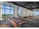 Modern billiards room with large windows showcasing lake view and lounge seating at 150 E Robinson St # 1219, Orlando, FL 32801