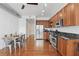 Well-equipped kitchen with stainless steel appliances, wooden cabinets, hardwood floors, and adjacent dining area at 150 E Robinson St # 1219, Orlando, FL 32801