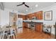 Well-equipped kitchen with stainless steel appliances, wooden cabinets, hardwood floors, and adjacent dining area at 150 E Robinson St # 1219, Orlando, FL 32801