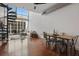 Bright living area with a dining area, large windows, spiral staircase, comfortable seating and hardwood floors at 150 E Robinson St # 1219, Orlando, FL 32801