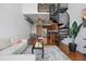 Bright, open living space with spiral staircase, hardwood floors, dining area and well-equipped kitchen at 150 E Robinson St # 1219, Orlando, FL 32801