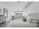 Cozy main bedroom showcases neutral tones, plush bedding, a bedside table, and access to the staircase at 150 E Robinson St # 1219, Orlando, FL 32801