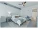Comfortable main bedroom features a large bed, ceiling fan, modern decor, and access to the ensuite bathroom at 150 E Robinson St # 1219, Orlando, FL 32801