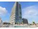 Luxurious pool deck with comfortable lounge chairs and a clear view of the modern high-rise condo building at 150 E Robinson St # 1219, Orlando, FL 32801
