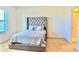 Bedroom featuring a tufted headboard, soft bedding, and natural light from the window at 156 Eagleview Loop, Davenport, FL 33837