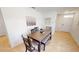 Cozy dining area with a wooden table, bench seating, and neutral decor at 156 Eagleview Loop, Davenport, FL 33837