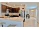 Well-lit kitchen with dark cabinetry, stainless steel appliances, and a breakfast bar at 156 Eagleview Loop, Davenport, FL 33837