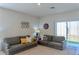 Comfortable living room with plush sofas, natural light, and neutral carpeting at 156 Eagleview Loop, Davenport, FL 33837