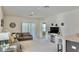 Open-concept living room with a sliding glass door and contemporary decor at 156 Eagleview Loop, Davenport, FL 33837