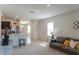 Bright living space connecting the kitchen and living areas with comfortable seating at 156 Eagleview Loop, Davenport, FL 33837