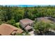 Aerial view of a tan, two story home, surrounded by lush greenery and neighboring residences at 1563 Song Sparrow Ct, Sanford, FL 32773