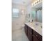 Bathroom with large vanity, mirror, and window at 1563 Song Sparrow Ct, Sanford, FL 32773
