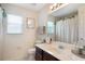 Bathroom with large vanity, mirror, and window at 1563 Song Sparrow Ct, Sanford, FL 32773