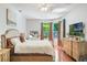 Serene bedroom with a comfortable bed, hardwood floors, and natural light at 1563 Song Sparrow Ct, Sanford, FL 32773