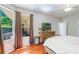 Bright bedroom with large windows, wooden dresser, and warm brown curtains at 1563 Song Sparrow Ct, Sanford, FL 32773