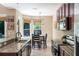 Eat-in kitchen with stainless appliances, a granite island with room for stools, and natural light at 1563 Song Sparrow Ct, Sanford, FL 32773