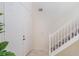 Bright foyer with stairs and tiled flooring, complemented by a white front door at 1563 Song Sparrow Ct, Sanford, FL 32773