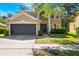 Inviting two-story home with a well-manicured lawn and a two-car garage at 1563 Song Sparrow Ct, Sanford, FL 32773
