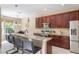 Kitchen with granite countertops, stainless steel appliances, pendant lighting, and breakfast bar seating at 1563 Song Sparrow Ct, Sanford, FL 32773